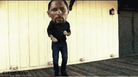 A Man With A Large Head Is Dancing On A Porch GIF