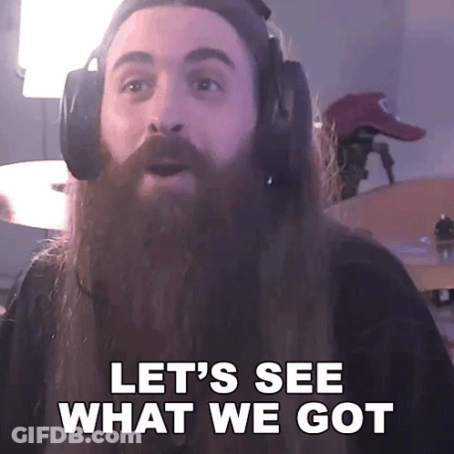 A Man With A Long Beard Wearing Headphones Says Let 'S See What We Got GIF