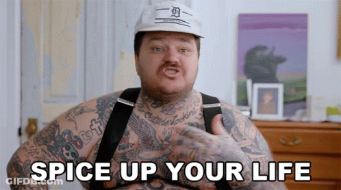 A Man With A Lot Of Tattoos Has The Words Spice Up Your Life On His Chest GIF