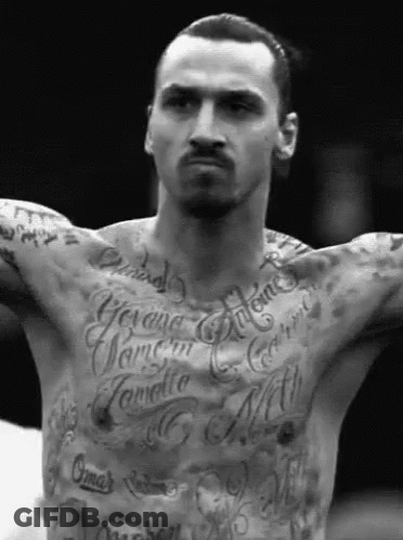 A Man With A Lot Of Tattoos On His Chest Including One That Says ' Gima ' GIF