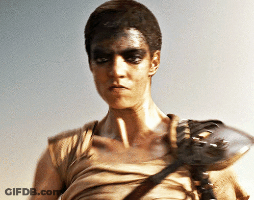 A Man With A Mask On His Face Holds A Gun GIF