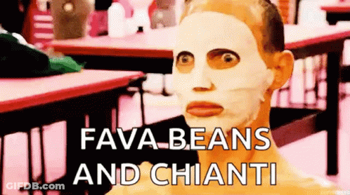 A Man With A Mask On His Face Is Sitting At A Table With The Words Fava Beans And Chianti . GIF