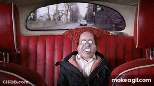 A Man With A Mask On His Face Is Sitting In A Car GIF
