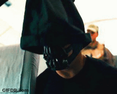 A Man With A Mask On His Face Is Sitting On A Plane GIF