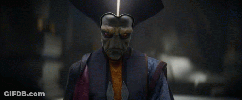 A Man With A Mask On His Face Is Wearing A Blue Jacket GIF