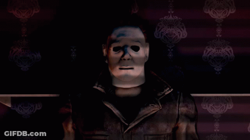 A Man With A Mask On His Face Stands In Front Of A Purple Wall GIF