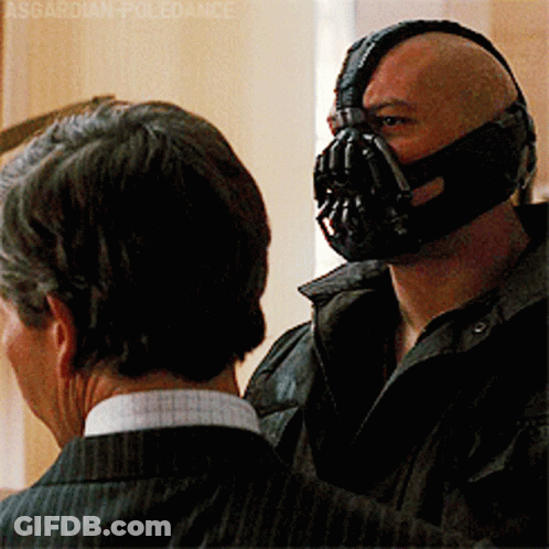 A Man With A Mask On His Face Talks To Another Man GIF