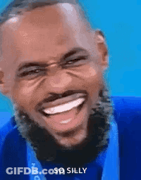 A Man With A Medal Around His Neck Is Laughing And Smiling . GIF