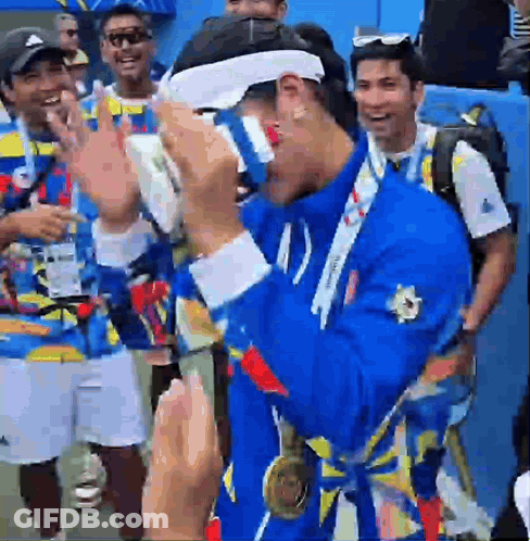 A Man With A Medal Around His Neck Is Wearing Glasses GIF