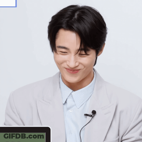 A Man With A Microphone And A Smiley Face On His Face GIF