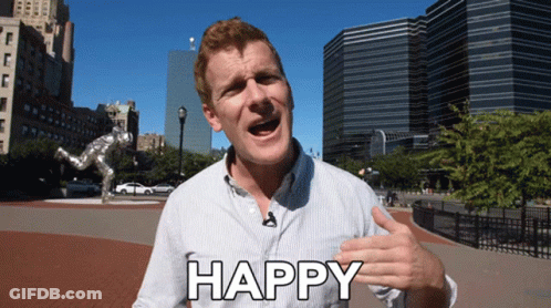 A Man With A Microphone In His Mouth Says Happy GIF