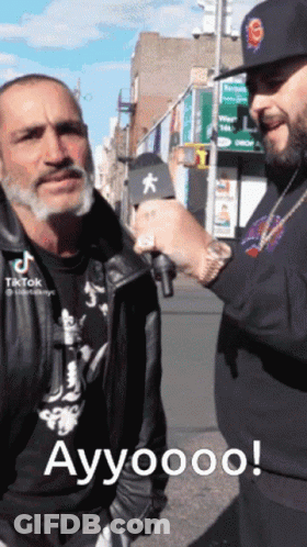 Man With Microphone Talking To Man With S Hat GIF