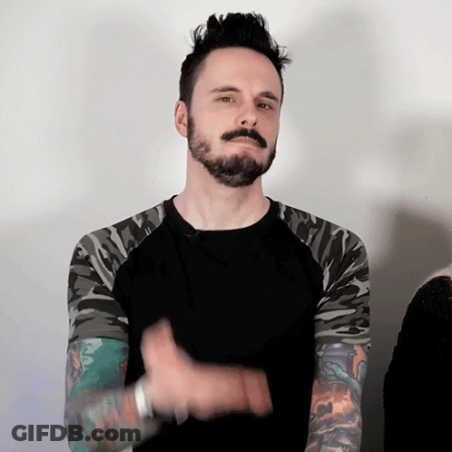 Man With Mohawk And Camo Sleeves Black Shirt GIF