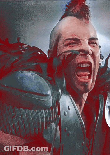 A Man With A Mohawk And Braces On His Teeth GIF