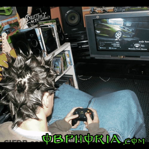 A Man With A Mohawk Is Playing A Video Game With The Website Obphoria.com Visible In The Corner GIF