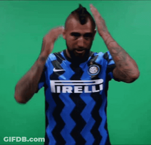 A Man With A Mohawk Is Wearing A Blue And Black Shirt With The Word Irelli On It GIF