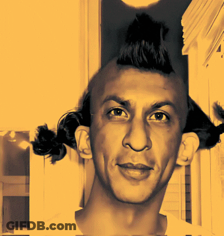 A Man With A Mohawk Looks At The Camera With A Yellow Background GIF