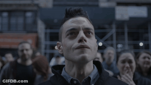 A Man With A Mohawk Looks Up At Something In The Sky GIF