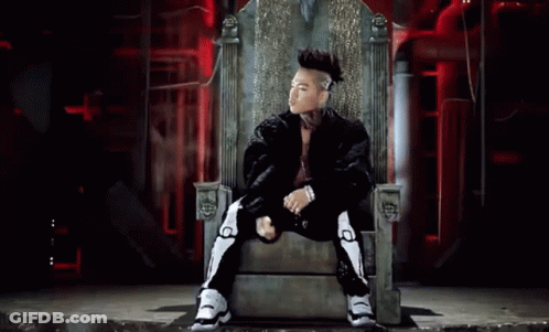 A Man With A Mohawk Sits On A Throne GIF