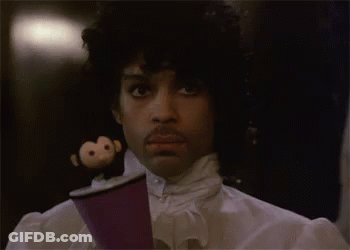 A Man With A Monkey On His Head Is Holding A Cup . GIF