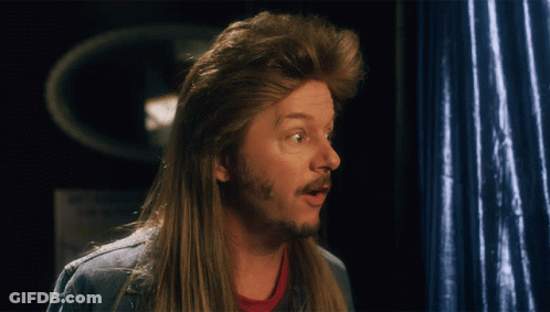 A Man With A Mullet And A Beard Is Making A Surprised Face GIF