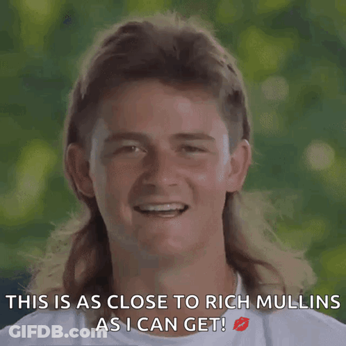 A Man With A Mullet Is Smiling With The Words " This Is As Close To Rich Mullins As I Can Get " GIF