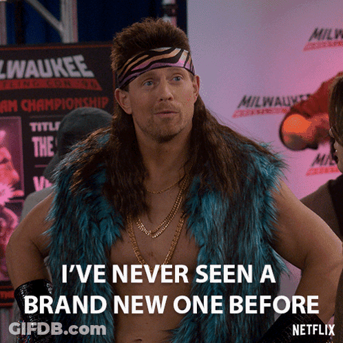 A Man With A Mullet Is Standing In Front Of A Sign That Says Milwaukee GIF