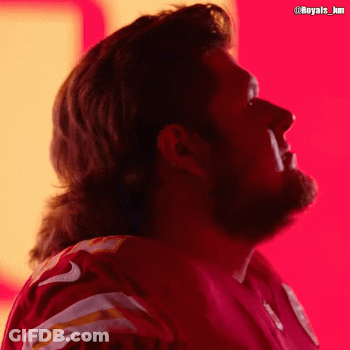 A Man With A Mullet Is Wearing A Red Jersey With The Number 9 On It GIF