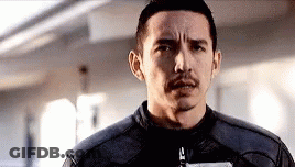 A Man With A Mustache And A Leather Jacket Is Looking At The Camera . GIF