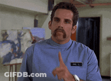 A Man With A Mustache And A Name Tag That Says Mr. L. GIF
