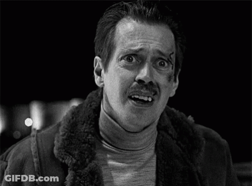 A Man With A Mustache And A Scar On His Face Is Making A Funny Face . GIF