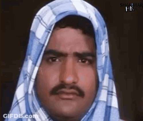 A Man With A Mustache And A Scarf Around His Head . GIF