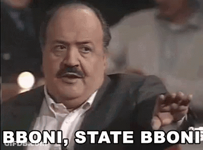 A Man With A Mustache And A Suit Is Making A Funny Face And Saying Bboni State Bboni . GIF