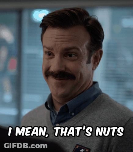 A Man With A Mustache And A Sweater That Says I Mean That 'S Nuts GIF