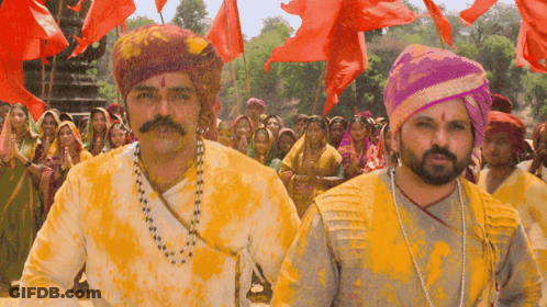 A Man With A Mustache And A Turban Is Covered In Yellow Paint GIF