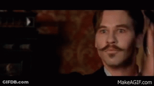 A Man With A Mustache And Beard Is Wearing A Red Shirt And A Red Shirt . GIF