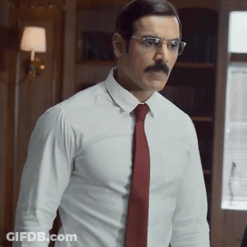 A Man With A Mustache And Glasses Wearing A White Shirt And Red Tie GIF