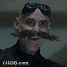 A Man With A Mustache And Goggles On His Head Is Eating Something GIF