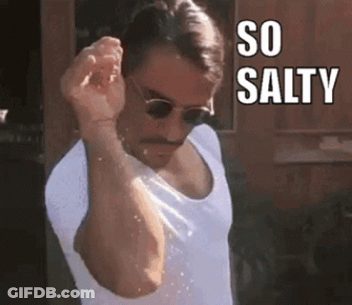 A Man With A Mustache And Sunglasses Is Pouring Salt On His Face . GIF