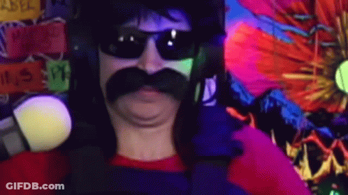 A Man With A Mustache And Sunglasses Is Standing In Front Of A Colorful Wall . GIF