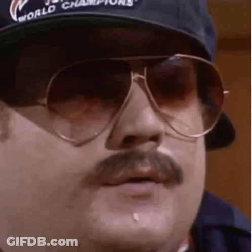 A Man With A Mustache And Sunglasses Is Wearing A Baseball Cap And Sunglasses . GIF