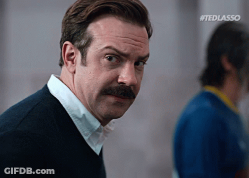 A Man With A Mustache And #Tedlasso Written On The Bottom Right GIF