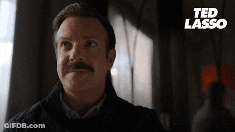 A Man With A Mustache And The Word Ted Lasso On The Bottom GIF