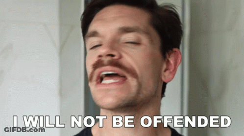 A Man With A Mustache Has His Eyes Closed And Says " I Will Not Be Offended " GIF