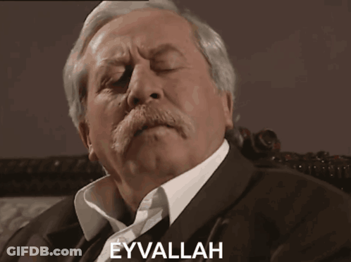 A Man With A Mustache Has The Word Eyvallah Written On His Face GIF
