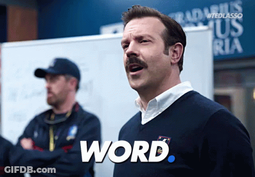 A Man With A Mustache Has The Word Word Written On His Shirt GIF