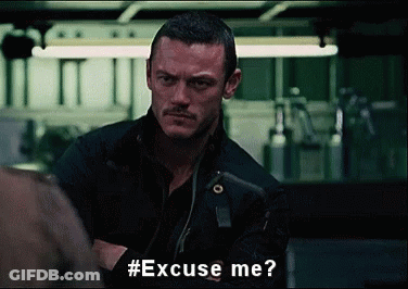 A Man With A Mustache Is Asking Someone To Excuse Him . GIF