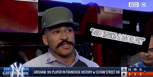 A Man With A Mustache Is Being Interviewed On A TV Screen GIF