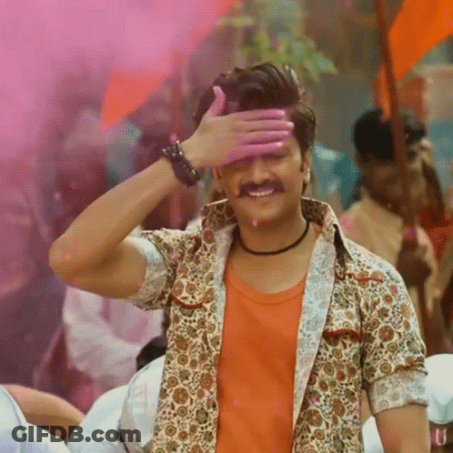 A Man With A Mustache Is Covering His Eyes With His Hand And Smiling GIF