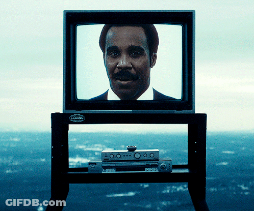 A Man With A Mustache Is Displayed On A Television Which Has A Sticker On It That Says ' Pioneer ' GIF